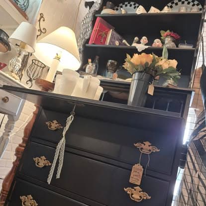 A black dresser in a living room.