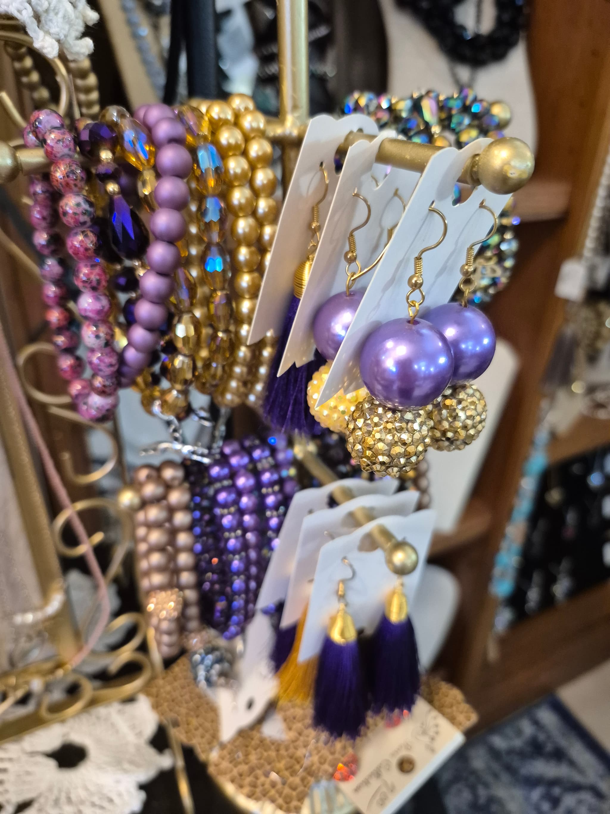 A black mannequin with a lot of charms on it.